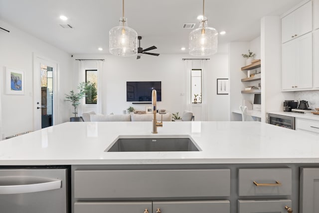 kitchen with visible vents, dishwasher, gray cabinetry, a sink, and recessed lighting