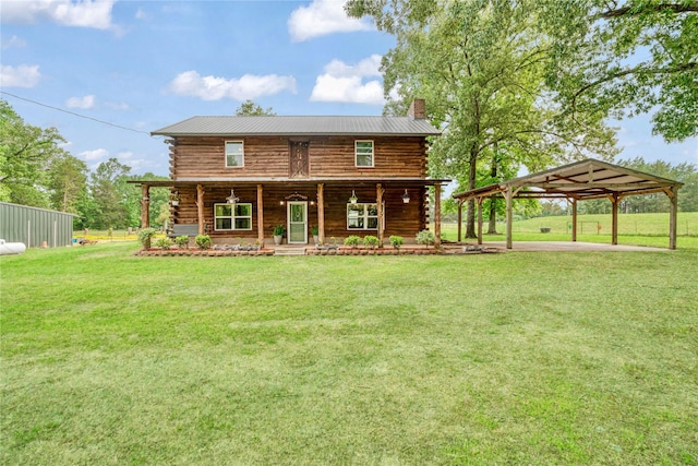 log home with covered porch, a chimney, log siding, a carport, and a front lawn