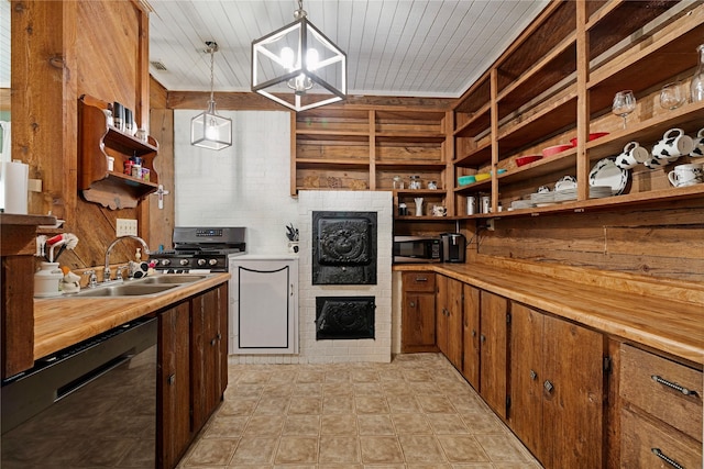 kitchen with open shelves, a fireplace, wooden walls, stainless steel microwave, and a sink