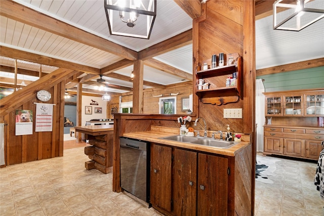 kitchen with beamed ceiling, black dishwasher, wooden walls, light countertops, and a sink
