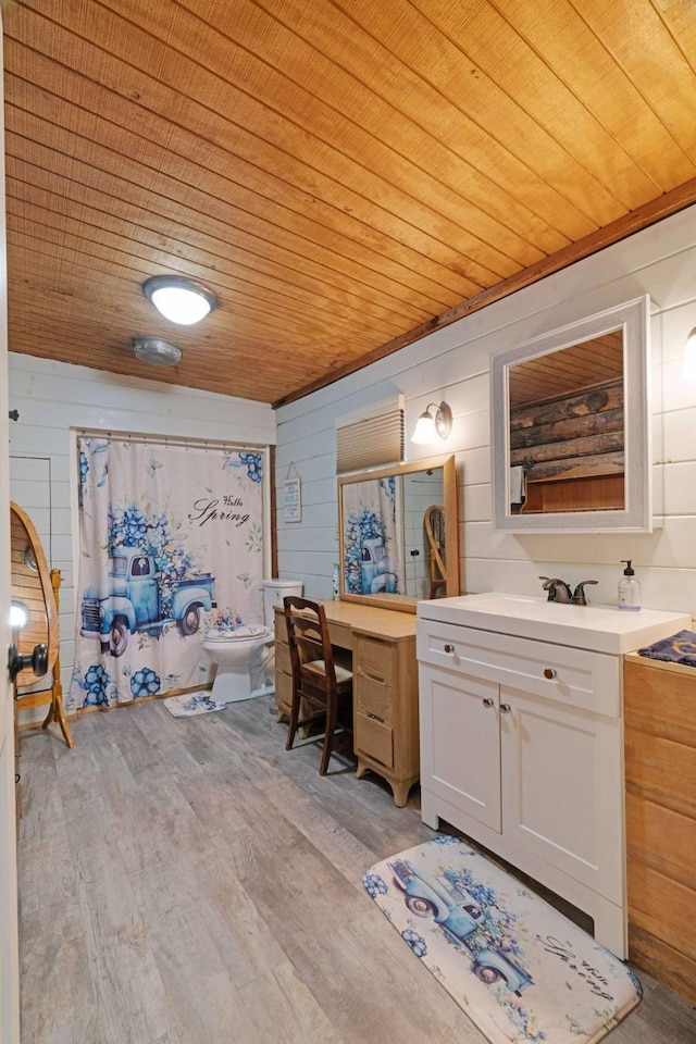 bathroom with wooden ceiling, vanity, and wood finished floors