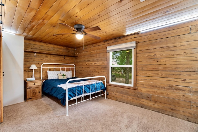 bedroom featuring wood walls, carpet, ceiling fan, and wood ceiling