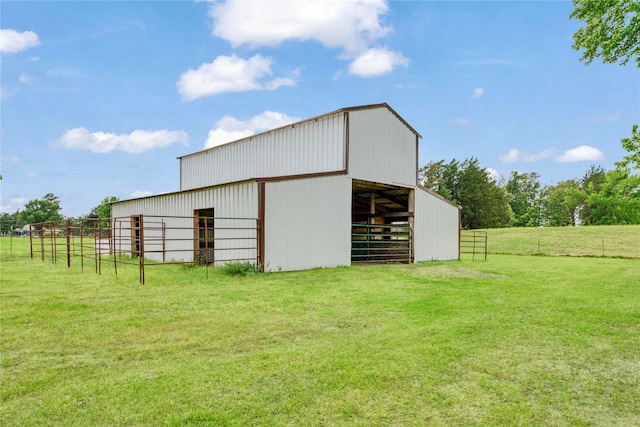 view of pole building with an exterior structure and a yard