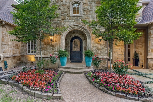 property entrance featuring stone siding