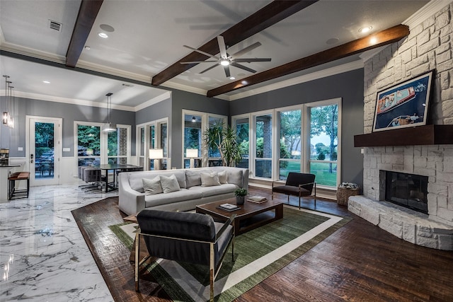 living area with a ceiling fan, a stone fireplace, visible vents, beamed ceiling, and recessed lighting