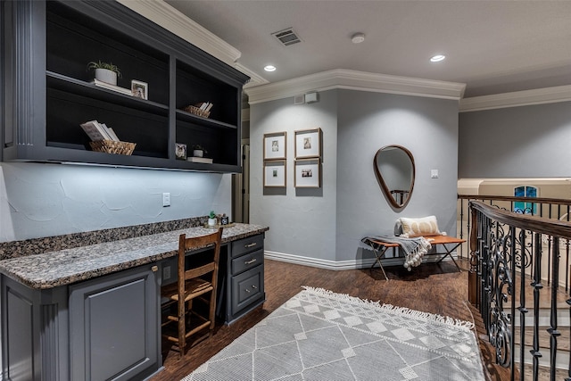 home office featuring dark wood-style flooring, built in desk, recessed lighting, visible vents, and ornamental molding