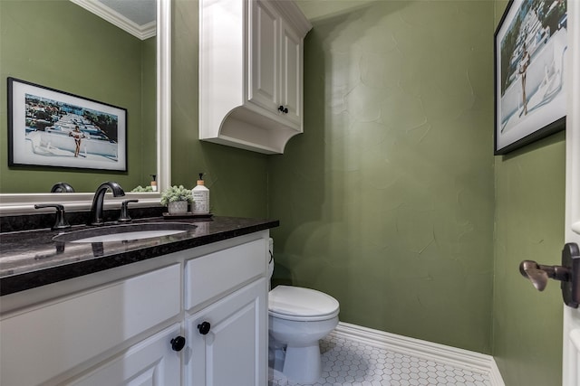 half bath featuring crown molding, tile patterned floors, baseboards, vanity, and toilet