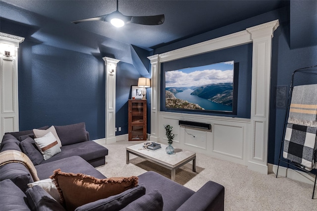 carpeted cinema featuring ceiling fan and decorative columns
