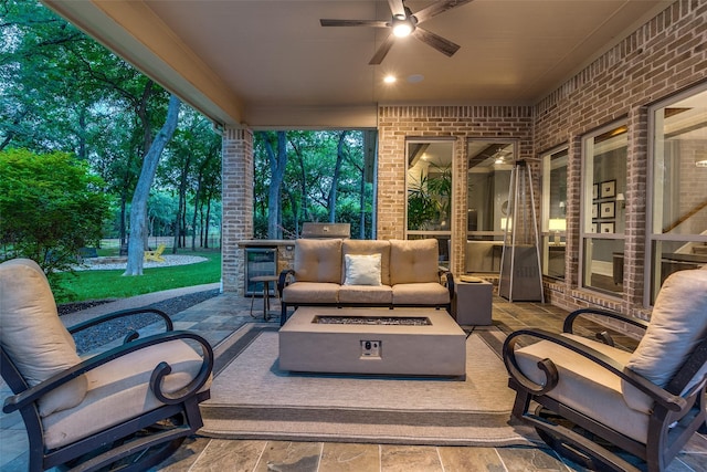 view of patio with a ceiling fan and an outdoor living space with a fire pit