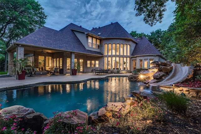 pool with a patio, an outdoor living space, ceiling fan, and a water slide