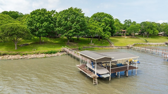 dock area with a lawn, boat lift, and a water view