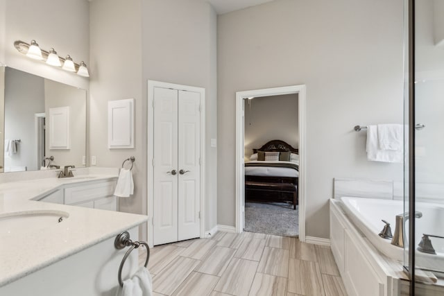 1101 Helmsley Dr, Frisco, TX 75036 - full bath with vanity, a high ceiling, baseboards, and a bath
