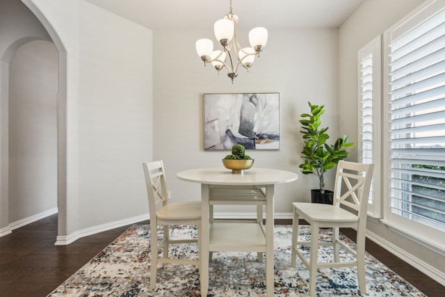 1101 Helmsley Dr, Frisco, TX 75036 - dining space featuring arched walkways, baseboards, an inviting chandelier, and dark wood-type flooring