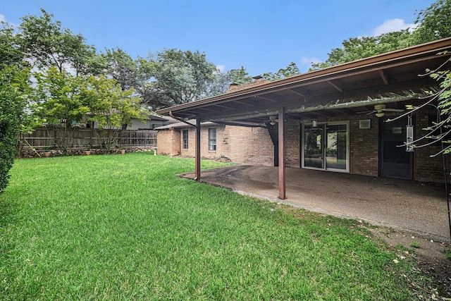 view of yard with a patio, ceiling fan, and fence