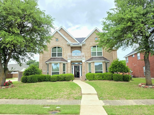 traditional-style house with brick siding and a front yard