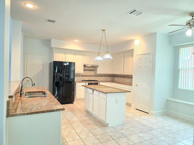 kitchen featuring a sink, a ceiling fan, light tile patterned floors, visible vents, and black fridge with ice dispenser