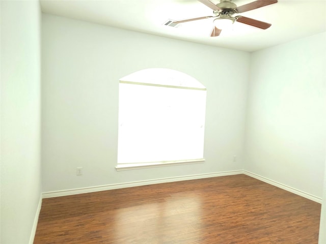 unfurnished room with baseboards, a ceiling fan, and wood finished floors