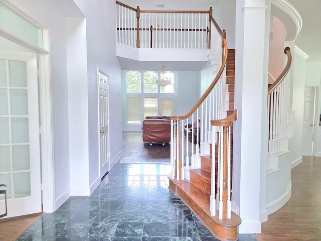 interior space with baseboards, a high ceiling, and stairway