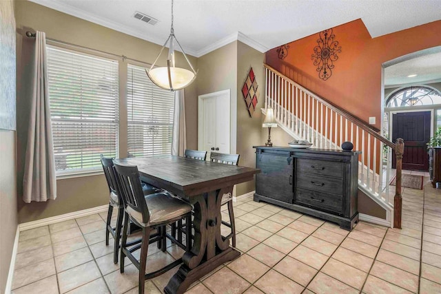 dining space featuring visible vents, baseboards, stairway, arched walkways, and light tile patterned floors