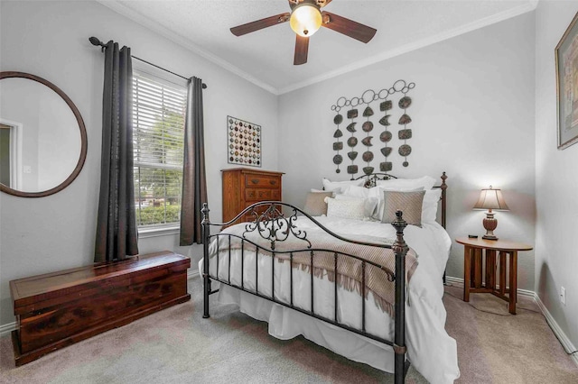 carpeted bedroom with crown molding, a ceiling fan, baseboards, and multiple windows