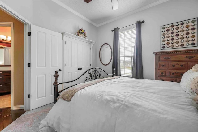 bedroom with a closet, ornamental molding, wood finished floors, ceiling fan, and a textured ceiling
