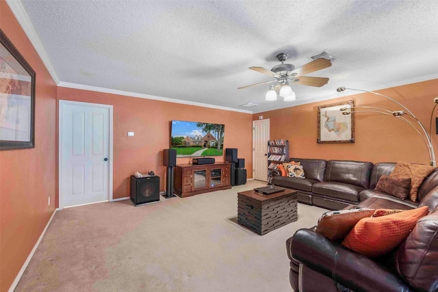 living area featuring ornamental molding, baseboards, ceiling fan, a textured ceiling, and carpet