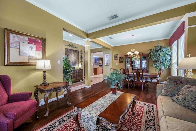 living room featuring visible vents, crown molding, arched walkways, hardwood / wood-style flooring, and a notable chandelier