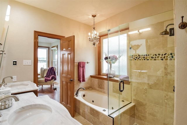 full bath featuring vanity, wood finished floors, a bath, a chandelier, and a shower stall