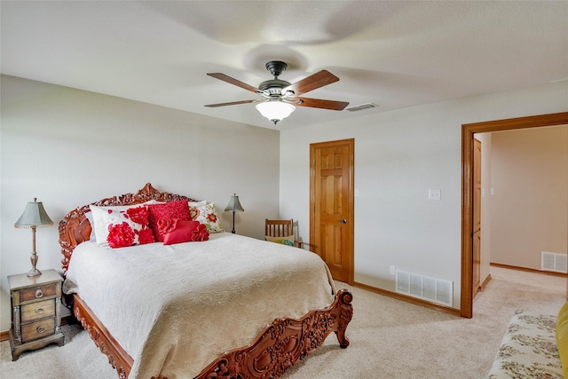carpeted bedroom featuring a ceiling fan, baseboards, and visible vents