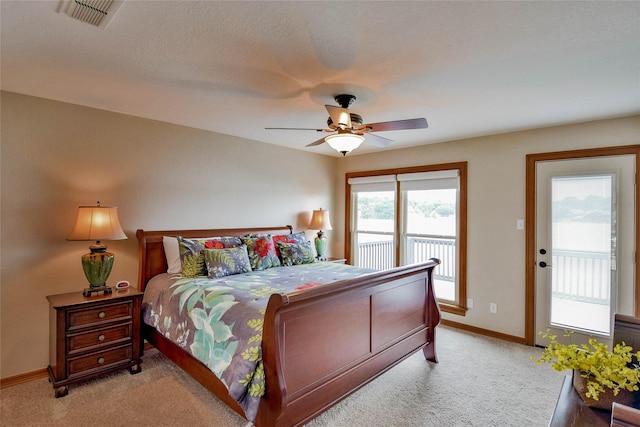 bedroom featuring visible vents, light carpet, baseboards, ceiling fan, and access to outside