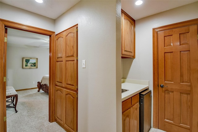 hall with recessed lighting, baseboards, and light carpet