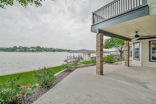 view of patio / terrace featuring a water view, ceiling fan, and a balcony
