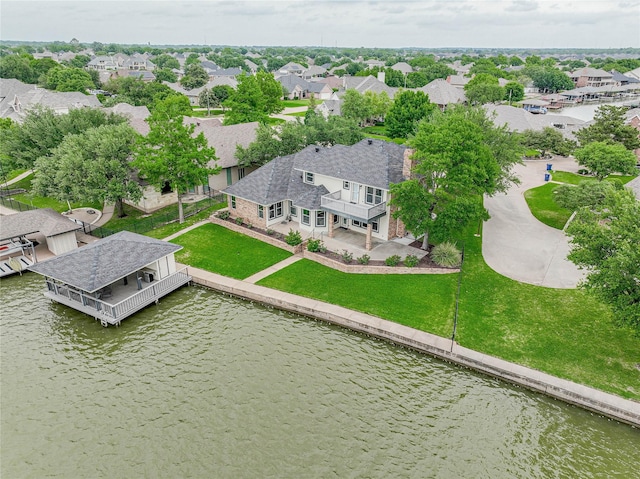 birds eye view of property with a residential view and a water view