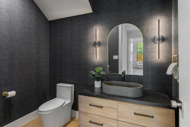 9409 Lenel Pl, Dallas, TX 75220 - bathroom featuring toilet, vanity, wood finished floors, and lofted ceiling