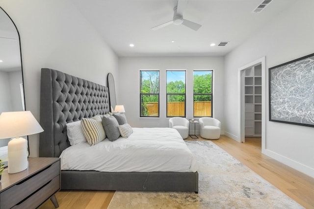 9409 Lenel Pl, Dallas, TX 75220 - bedroom with wood finished floors, recessed lighting, baseboards, a walk in closet, and a ceiling fan