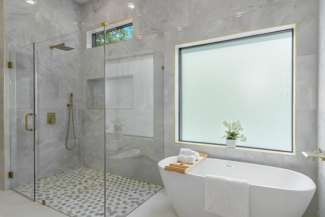 9409 Lenel Pl, Dallas, TX 75220 - bathroom with a shower stall, a freestanding tub, and tile walls