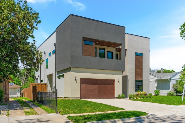 9409 Lenel Pl, Dallas, TX 75220 - contemporary home with an attached garage, concrete driveway, and stucco siding