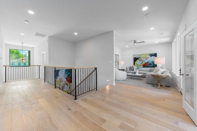 9409 Lenel Pl, Dallas, TX 75220 - corridor with an upstairs landing, light wood-type flooring, and recessed lighting