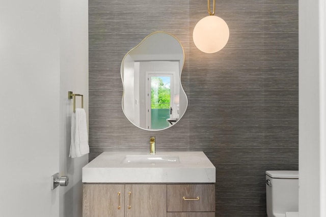 9409 Lenel Pl, Dallas, TX 75220 - half bathroom with vanity, tile walls, and toilet