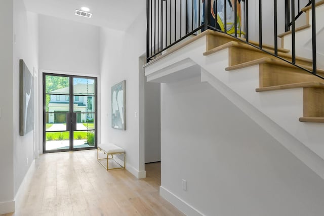 9409 Lenel Pl, Dallas, TX 75220 - foyer featuring baseboards, wood finished floors, stairway, and a high ceiling