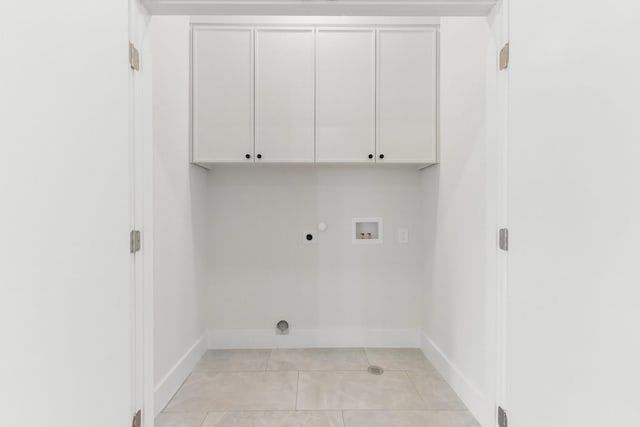 9409 Lenel Pl, Dallas, TX 75220 - laundry area with cabinet space, hookup for a washing machine, gas dryer hookup, light tile patterned flooring, and baseboards