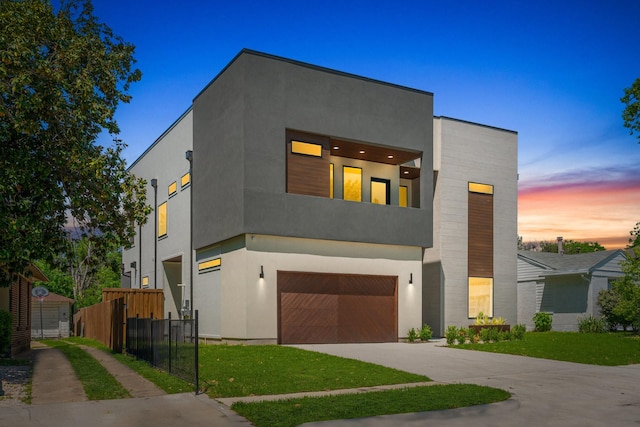 9409 Lenel Pl, Dallas, TX 75220 - contemporary house featuring a garage, concrete driveway, and stucco siding