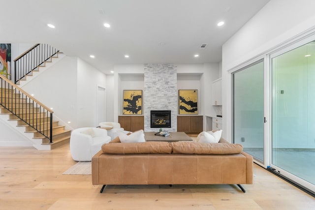 9409 Lenel Pl, Dallas, TX 75220 - living area featuring light wood-style flooring, stairs, recessed lighting, and a fireplace