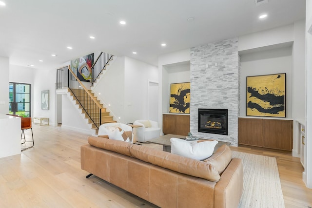9409 Lenel Pl, Dallas, TX 75220 - living room featuring light wood-type flooring, stairs, a large fireplace, and recessed lighting
