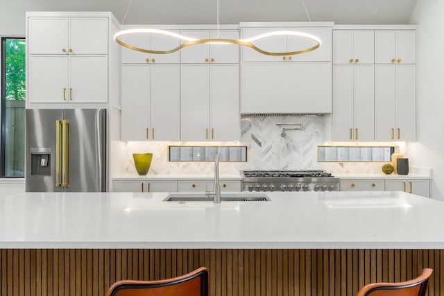 9409 Lenel Pl, Dallas, TX 75220 - kitchen featuring high end refrigerator, a sink, stove, and backsplash