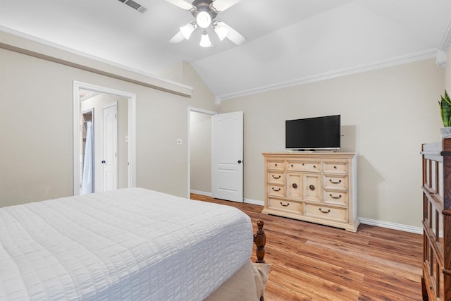 bedroom with light wood-style flooring, a ceiling fan, baseboards, vaulted ceiling, and ornamental molding