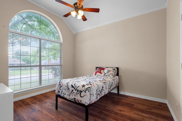 bedroom with wood finished floors, ornamental molding, baseboards, and lofted ceiling