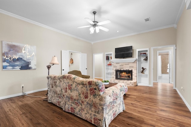 living area with crown molding, a ceiling fan, wood finished floors, and visible vents