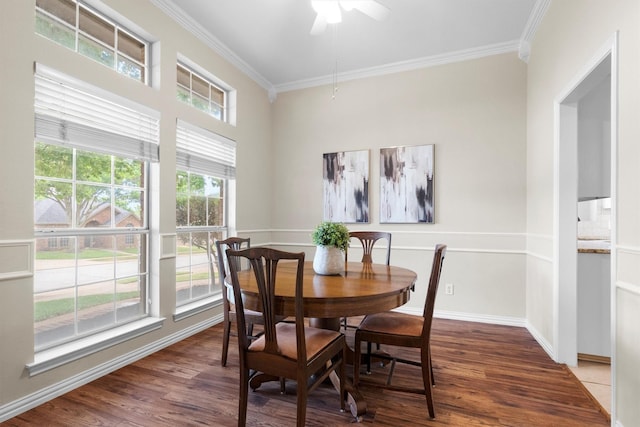 dining room featuring baseboards, ornamental molding, a ceiling fan, and wood finished floors