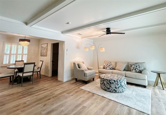 living room with visible vents, beam ceiling, baseboards, a ceiling fan, and light wood-style flooring
